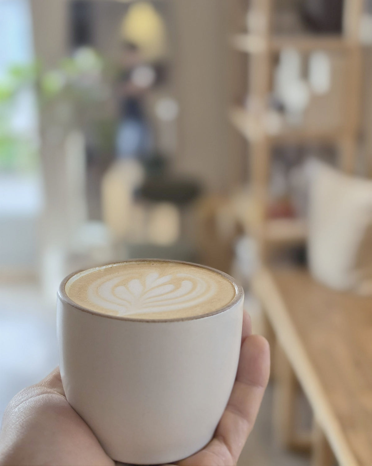 Latte with rosetta art held in the café
